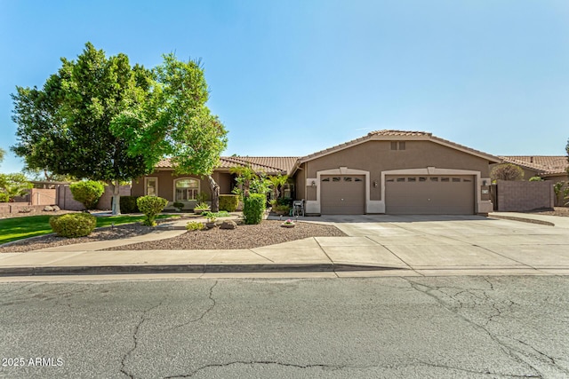 13609 W Vermont Ave, Litchfield Park, AZ 85340 - mediterranean / spanish-style house with driveway, stucco siding, fence, an attached garage, and a tiled roof