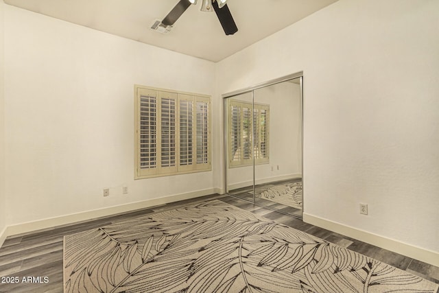 13609 W Vermont Ave, Litchfield Park, AZ 85340 - empty room with baseboards, dark wood-style flooring, visible vents, and a ceiling fan