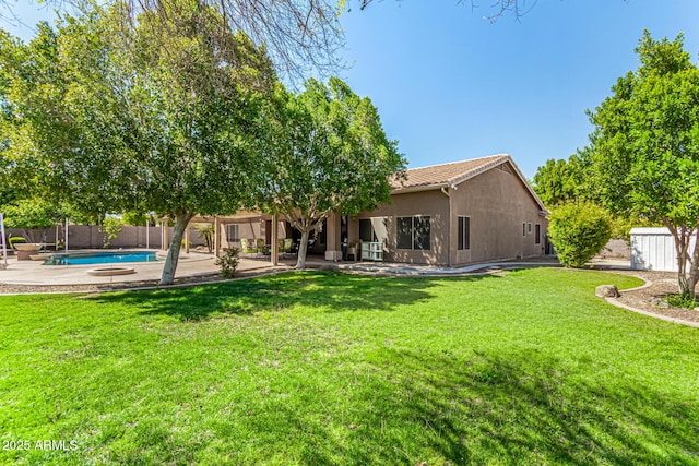 13609 W Vermont Ave, Litchfield Park, AZ 85340 - back of house featuring a tile roof, stucco siding, a fenced backyard, a yard, and a patio area