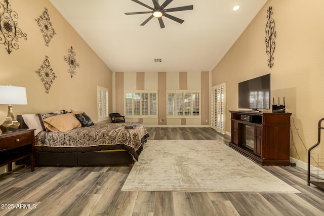 13609 W Vermont Ave, Litchfield Park, AZ 85340 - bedroom with baseboards, visible vents, high vaulted ceiling, and wood finished floors