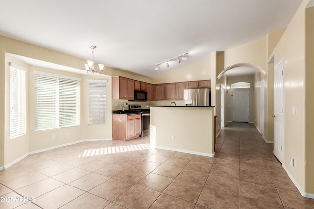 kitchen featuring a chandelier, appliances with stainless steel finishes, light tile patterned floors, and pendant lighting