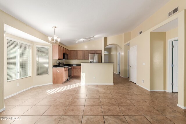 kitchen featuring stainless steel appliances, pendant lighting, an inviting chandelier, a center island, and light tile patterned flooring