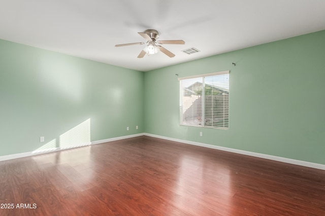 empty room with hardwood / wood-style flooring and ceiling fan