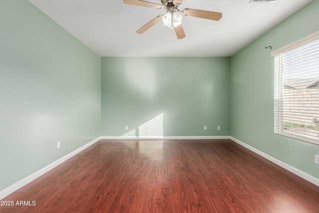 spare room with ceiling fan and wood-type flooring