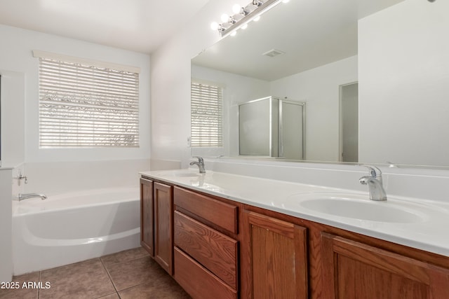 bathroom with tile patterned floors, separate shower and tub, and vanity