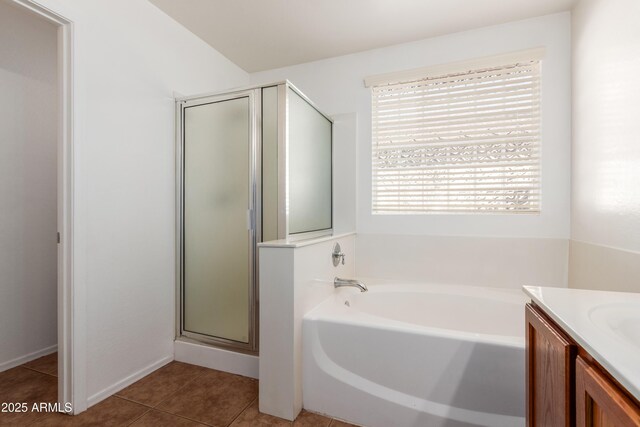 bathroom with tile patterned floors, vanity, and separate shower and tub