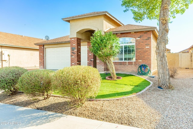 view of front of home featuring a garage and a front yard