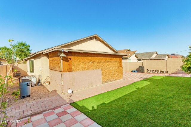 back of house with a lawn