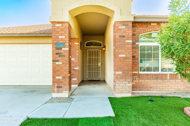 view of exterior entry with a garage