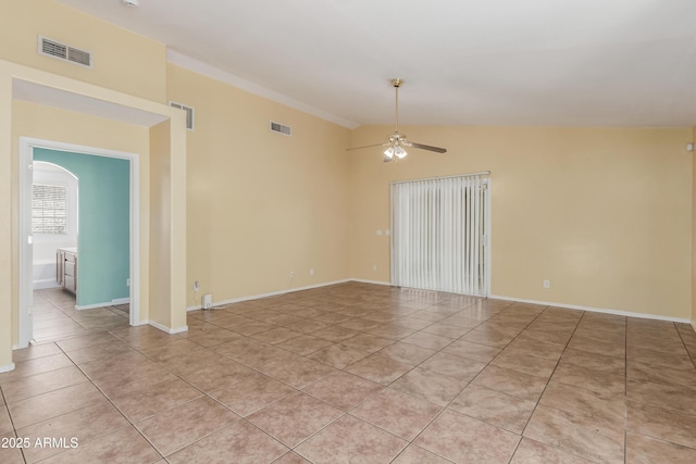 tiled spare room featuring ceiling fan and vaulted ceiling