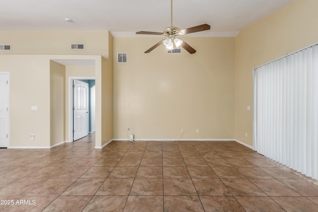 tiled spare room featuring ceiling fan