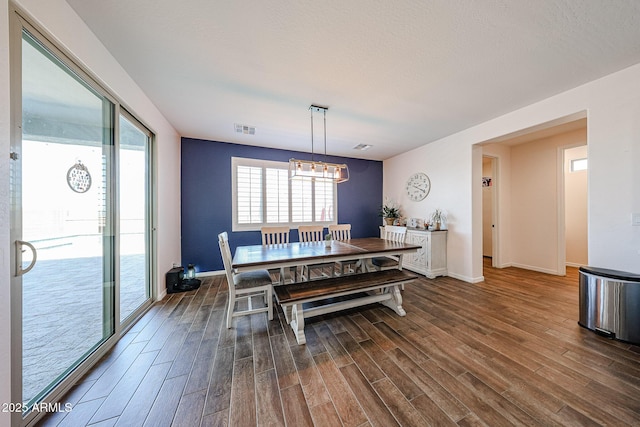 25051 N 140th Dr, Surprise, AZ 85387 - dining space featuring a chandelier, dark wood-style flooring, and baseboards