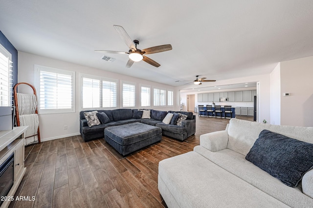 25051 N 140th Dr, Surprise, AZ 85387 - living room featuring dark wood finished floors, ceiling fan, and baseboards