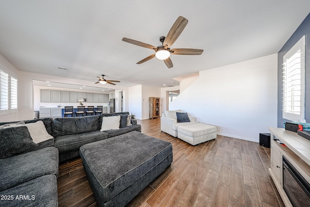 25051 N 140th Dr, Surprise, AZ 85387 - living area featuring ceiling fan, wood finished floors, and baseboards