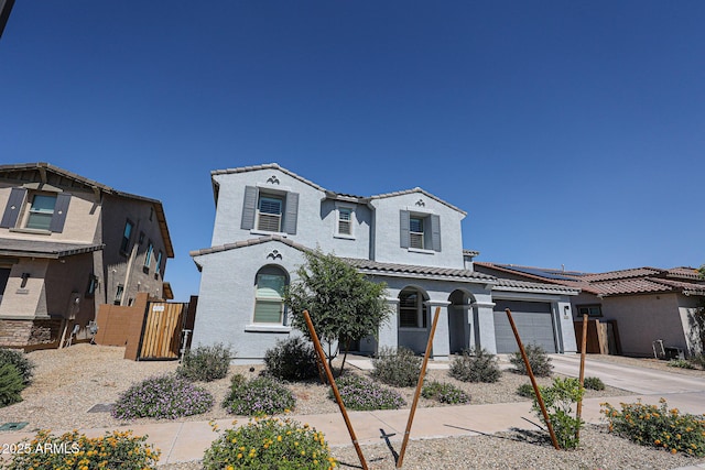 25051 N 140th Dr, Surprise, AZ 85387 - mediterranean / spanish-style home featuring a tiled roof, stucco siding, a garage, and concrete driveway