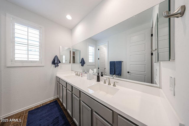 25051 N 140th Dr, Surprise, AZ 85387 - full bath with wood finished floors, baseboards, and double vanity