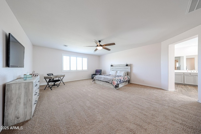 25051 N 140th Dr, Surprise, AZ 85387 - bedroom with baseboards, light colored carpet, a ceiling fan, and ensuite bath