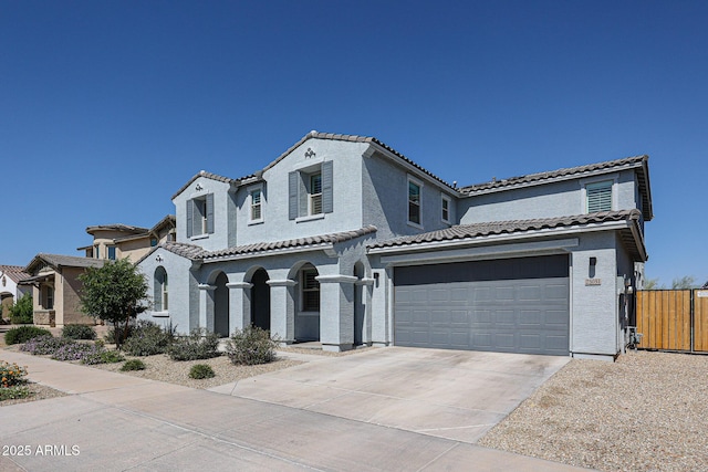 25051 N 140th Dr, Surprise, AZ 85387 - mediterranean / spanish-style house with a tile roof, driveway, a garage, and stucco siding