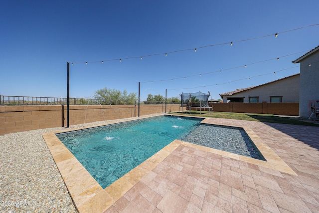 25051 N 140th Dr, Surprise, AZ 85387 - view of pool featuring a trampoline, a patio, and a fenced backyard