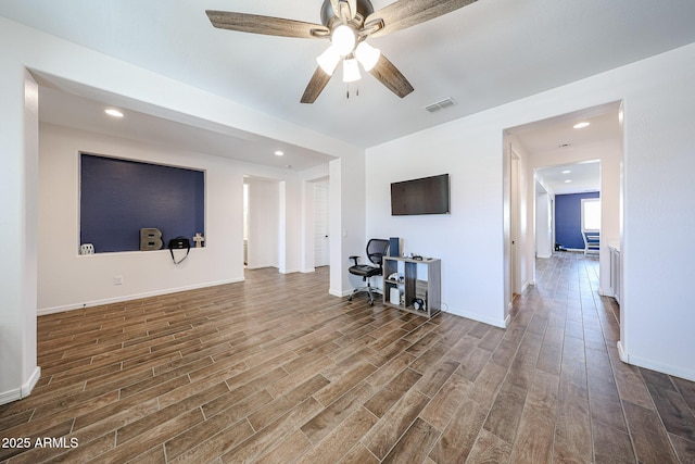 25051 N 140th Dr, Surprise, AZ 85387 - living room with wood finished floors, ceiling fan, an office area, baseboards, and recessed lighting