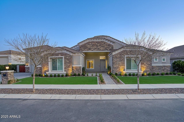 craftsman-style home featuring driveway, a front lawn, and stucco siding