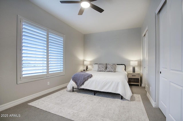 bedroom featuring carpet floors, a closet, ceiling fan, and baseboards