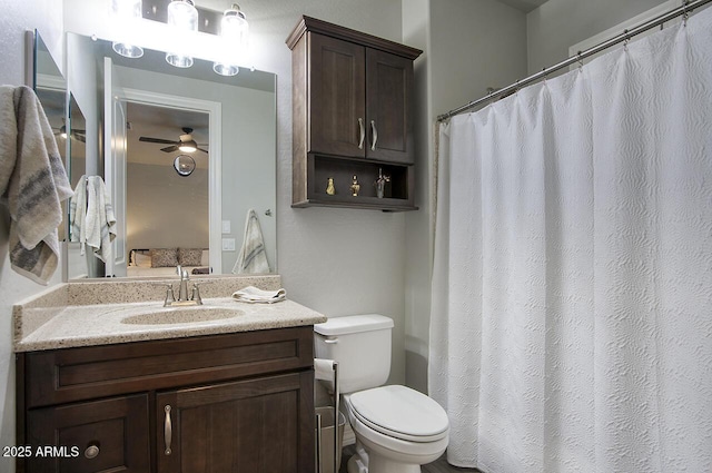 ensuite bathroom featuring connected bathroom, ceiling fan, vanity, and toilet