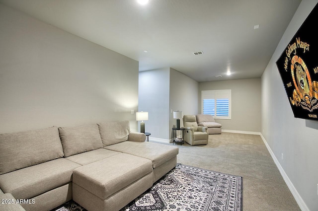 carpeted living area featuring visible vents and baseboards