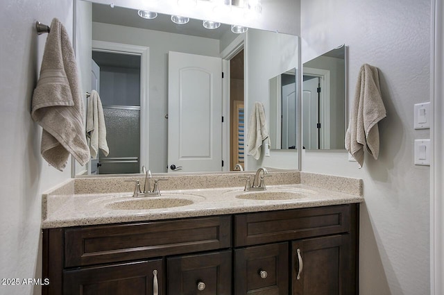 full bath featuring a sink and double vanity