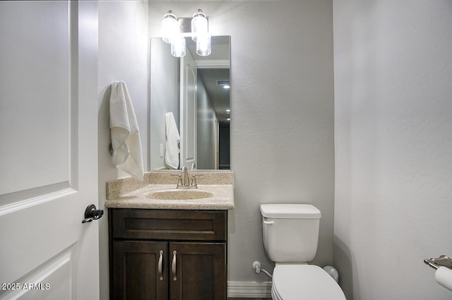 bathroom featuring toilet and vanity