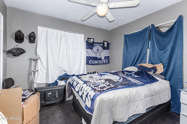 bedroom with ceiling fan and dark hardwood / wood-style flooring