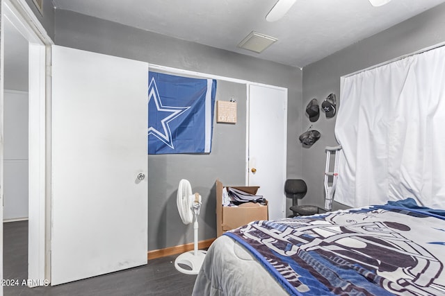 bedroom featuring ceiling fan and dark hardwood / wood-style floors