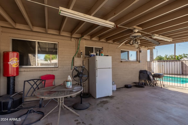 view of patio featuring a fenced in pool and ceiling fan