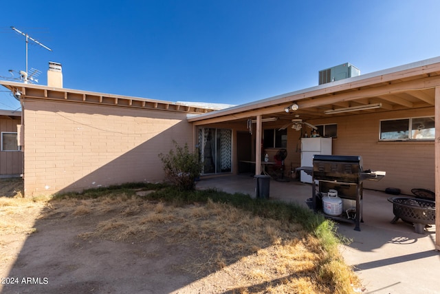 back of property with a patio, ceiling fan, and central AC