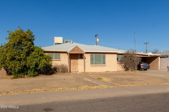 ranch-style home with a carport