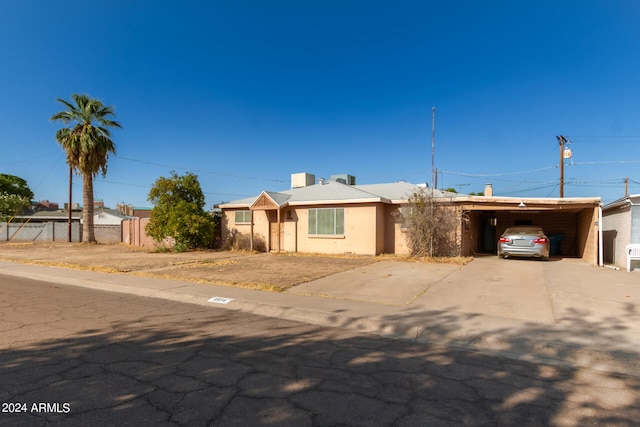 single story home featuring a carport