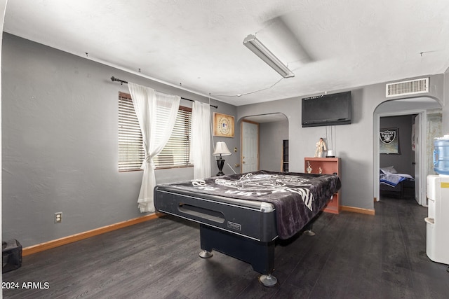 bedroom featuring dark hardwood / wood-style flooring and billiards