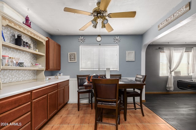 dining space with light hardwood / wood-style floors and ceiling fan