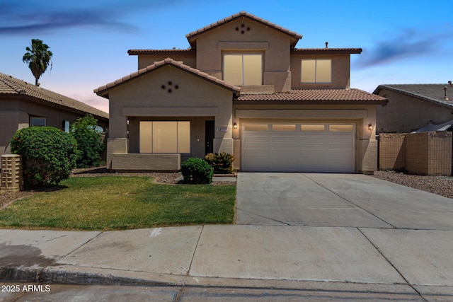 12426 W Adams St, Avondale, AZ 85323 - mediterranean / spanish home featuring a tile roof, driveway, stucco siding, and an attached garage
