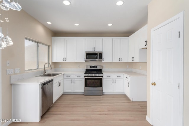 12426 W Adams St, Avondale, AZ 85323 - kitchen featuring appliances with stainless steel finishes, a sink, light wood-type flooring, recessed lighting, and white cabinets