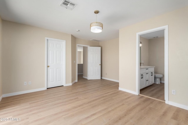 12426 W Adams St, Avondale, AZ 85323 - unfurnished bedroom featuring light wood finished floors, baseboards, and ensuite bathroom