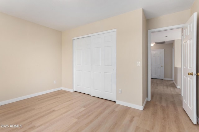12426 W Adams St, Avondale, AZ 85323 - unfurnished bedroom with light wood-type flooring, baseboards, and a closet