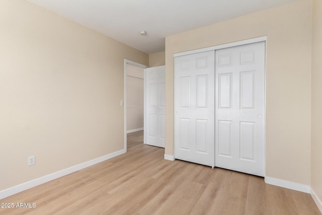 12426 W Adams St, Avondale, AZ 85323 - unfurnished bedroom featuring light wood-type flooring, baseboards, and a closet