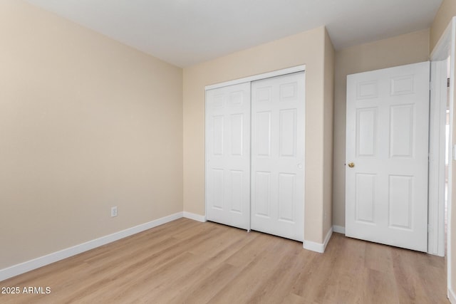 12426 W Adams St, Avondale, AZ 85323 - unfurnished bedroom with light wood-type flooring, baseboards, and a closet