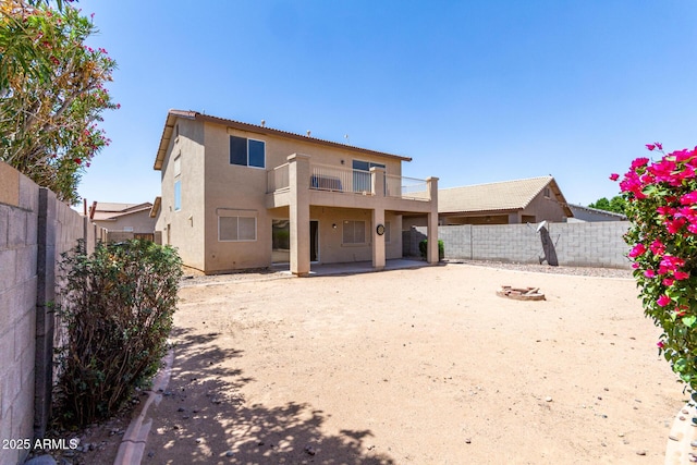 12426 W Adams St, Avondale, AZ 85323 - rear view of house featuring a balcony, a fenced backyard, stucco siding, and a patio area