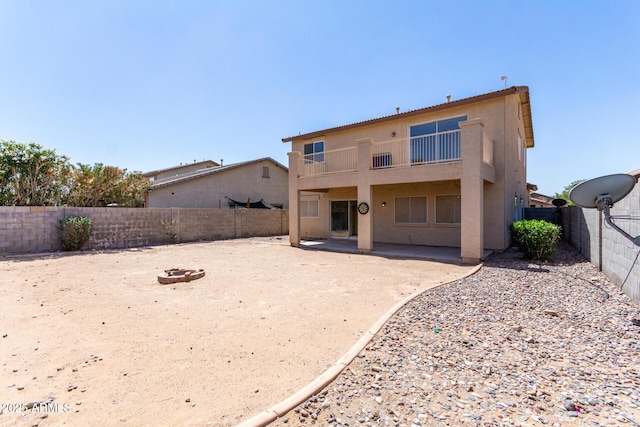 12426 W Adams St, Avondale, AZ 85323 - back of property featuring a balcony, a fenced backyard, a patio area, and stucco siding