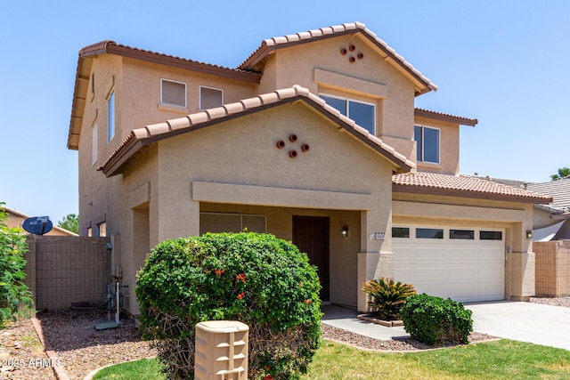 12426 W Adams St, Avondale, AZ 85323 - view of front of house featuring a tiled roof, driveway, fence, and stucco siding