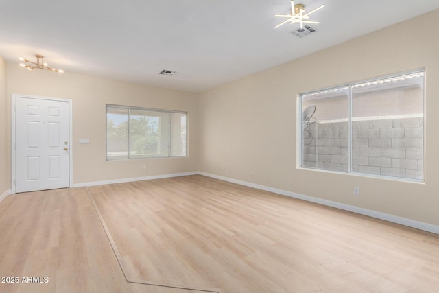 12426 W Adams St, Avondale, AZ 85323 - spare room with light wood-type flooring, baseboards, a chandelier, and a ceiling fan