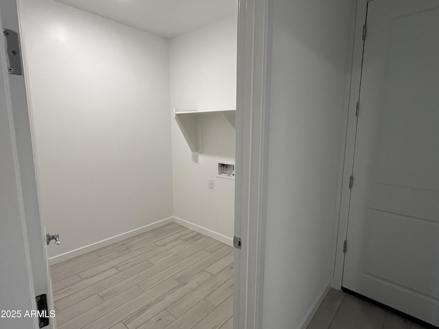 laundry room with washer hookup and light hardwood / wood-style flooring