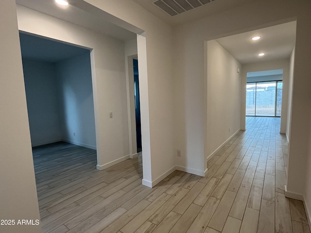 hall with light hardwood / wood-style flooring